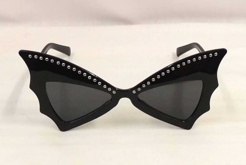 Black butterfly wing sunglasses with sharp, angular frames and rhinestone detailing along the top edge.